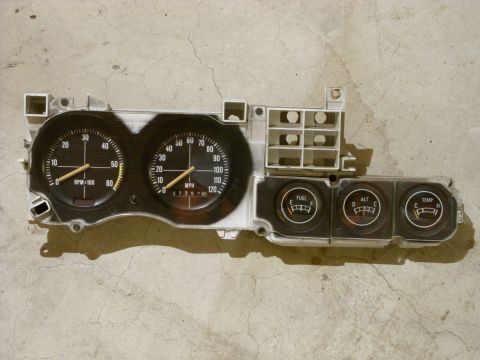 1988 Ford Bronco - Instrument cluster a speedometer, tachometer, and auxiliary gauges for fuel, alternator, and temperature.