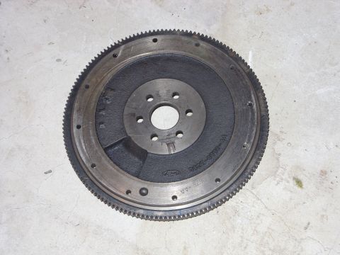 1988 Ford Bronco - Ford flywheel part number E2ZE-6380-BA is shown on a concrete surface.