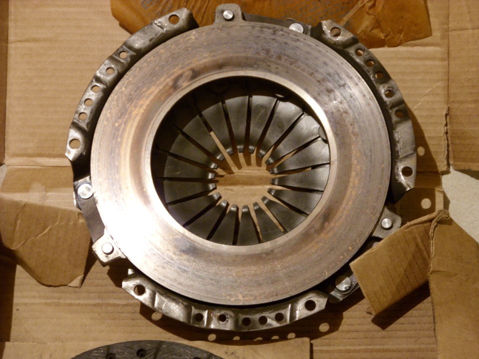 Clutch pressure plate with diaphragm springs, resting on cardboard