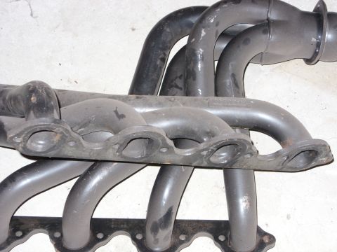 1988 Ford Bronco - Close-up view of an exhaust manifold, showing its complex pipe structure and mounting flange.