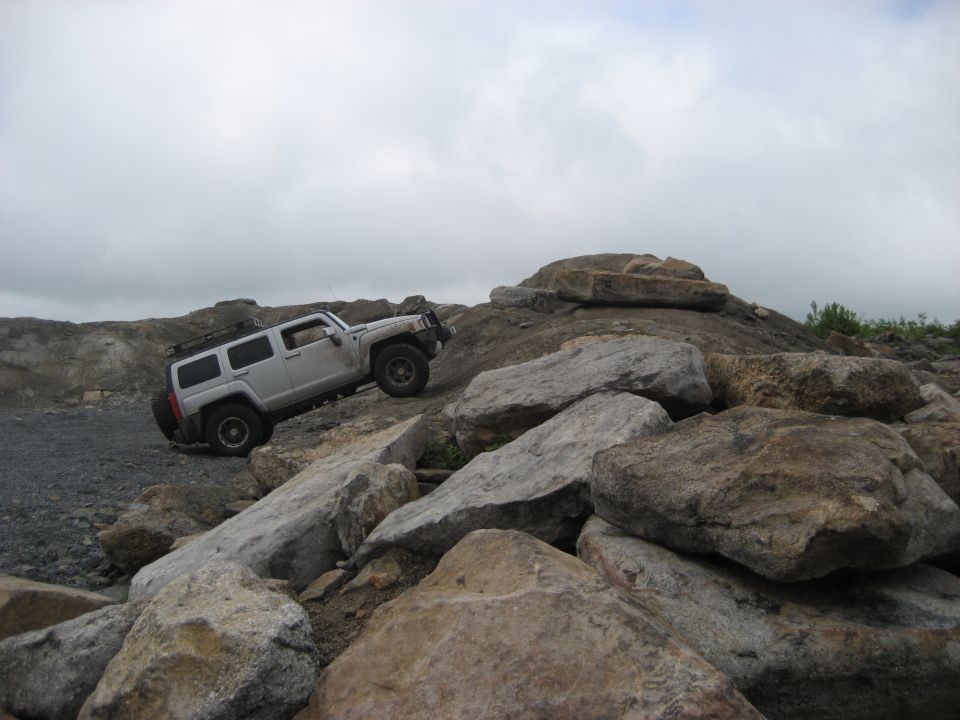 Silver Hummer H3 climbing rocky terrain