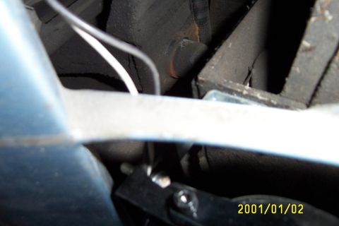 1992 Mercury Grand Marquis - Looking up into the bumper/front facia, on drivers side. The back of foglight mount is visible (black @ bottom), and the L-Bracket is sligh…