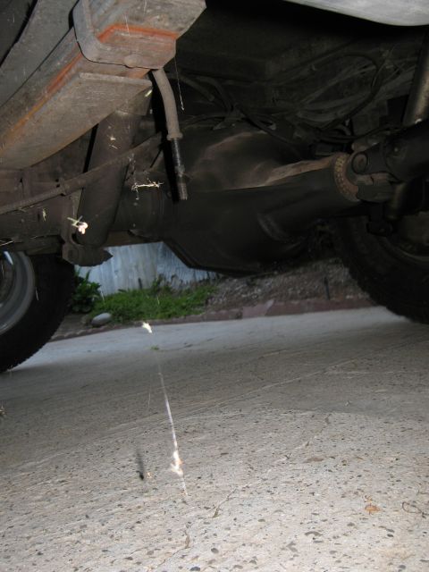 1986 Ford Bronco - Close-up view of the rear axle and suspension system of an unidentified vehicle.