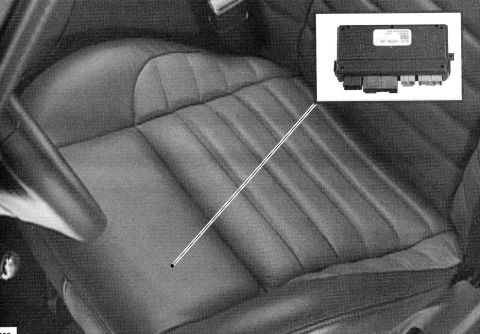 2007 Ford Mustang - An electronic control module is shown inset against a car's interior seat. The module has multiple connectors and a label with text.