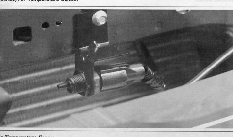 2007 Ford Mustang - Close-up of an air temperature sensor assembly, likely from a vehicle's front end.