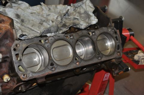1996 Ford Bronco - Close-up view of an engine block with pistons, mounted on a stand for repair or inspection.