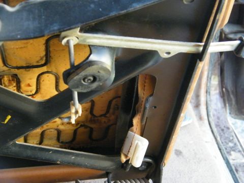 1982 Ford Bronco - Close-up view of a vehicle's seat mechanism, revealing the internal springs and upholstery structure.