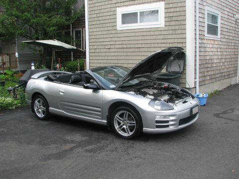 2001 Mitsubishi Eclipse - Silver 2001 Mitsubishi Eclipse convertible with the hood open, parked in a driveway.