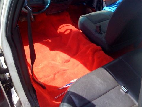 2003 Ford Crown Victoria - Interior view of a car with custom red carpeting and gray seats.