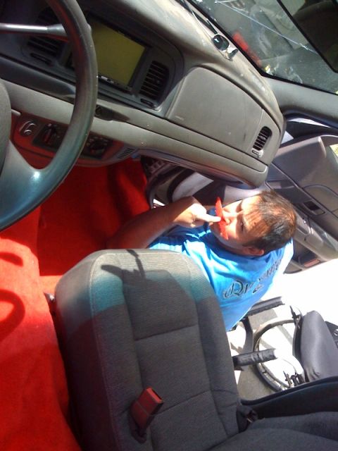 2003 Ford Crown Victoria - Person working inside the interior of a 2003 Ford Crown Victoria.