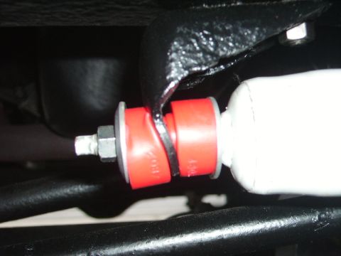 1978 Ford Bronco - Red polyurethane bushings are installed on a vehicle's shock absorber assembly.