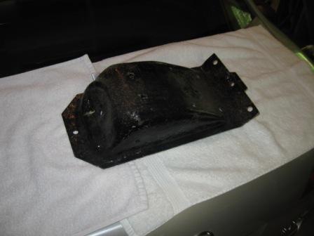 1993 Ford Bronco - This black metal part is shown on a white towel, likely for sale.