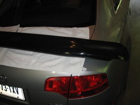 1993 Ford Bronco - A black rear spoiler is placed on a white towel on the trunk of a silver Audi A6.