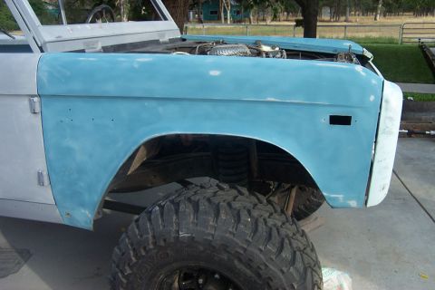 1976 Ford Bronco - This 1976 Ford Bronco is undergoing restoration, showing its bodywork in primer and large off-road tires.