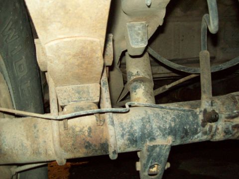 1985 Ford Bronco - Underside view of a vehicle's rear axle and suspension system components.