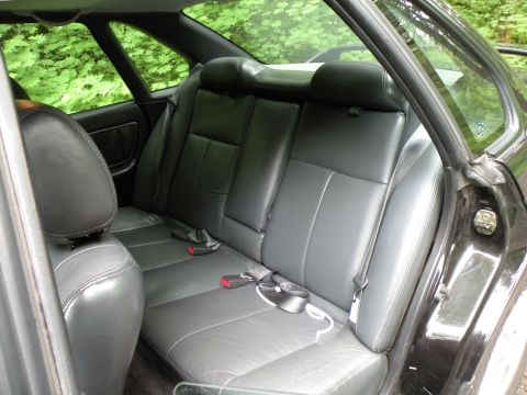 1998 Subaru Legacy - Interior view of the back seats and seatbelts of a car.