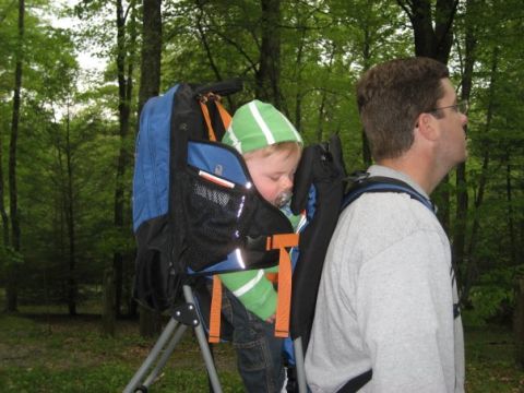 1996 Ford Bronco - A man carries a child in a backpack carrier while walking through a wooded area.
