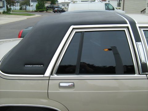 1988 Mercury Grand Marquis - A 1988 Mercury Grand Marquis is shown from the side, a black vinyl top and chrome trim.