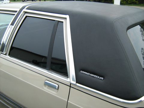 1988 Mercury Grand Marquis - A 1988 Mercury Grand Marquis is shown from the side, highlighting its tan paint and black vinyl roof.