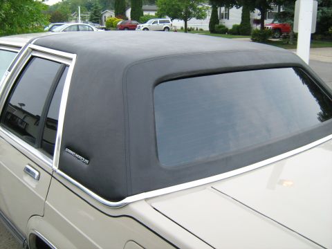1988 Mercury Grand Marquis - Close-up of the vinyl top and rear quarter panel of a 1988 Mercury Grand Marquis.