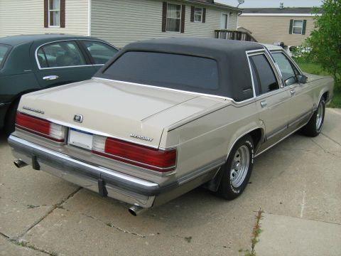 1988 Mercury Grand Marquis - This 1988 Mercury Grand Marquis features a distinctive black vinyl roof and a rear-facing view.