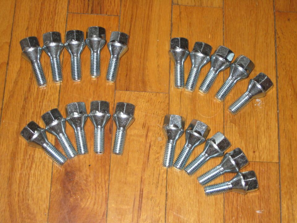 Set of lug nuts on a wooden floor