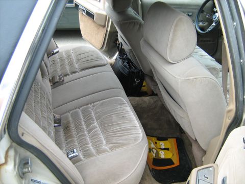 1988 Mercury Grand Marquis - The interior of a 1988 Mercury Grand Marquis features plush velour seating and a glimpse of the steering wheel and dashboard.