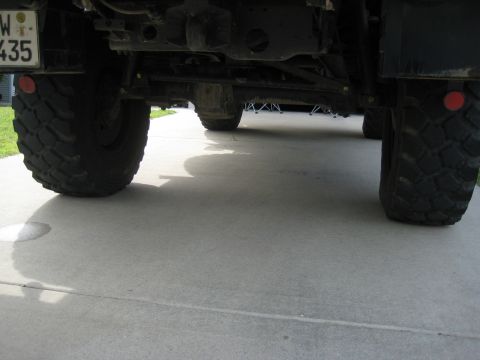 1995 Ford Bronco - The underside of a heavy-duty vehicle is captured, highlighting its robust tires and suspension system.