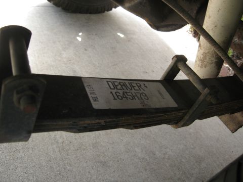 1986 Ford Bronco - Close-up of a vehicle's leaf spring showing a "Denver 1645H79" sticker and "Made in USA" text.