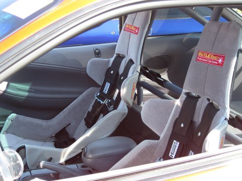 1994 Ford Probe - The interior features racing seats equipped with Butlerbuilt and Hooker Harness systems, suggesting a performance-oriented build.