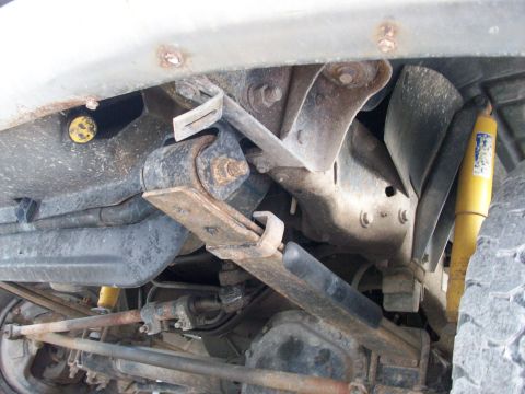 1995 Ford C-350 (Centurion Conversions) - Underside view of 1995 Ford C-350 (Centurion Conversions) suspension components, including leaf springs and shock absorber.