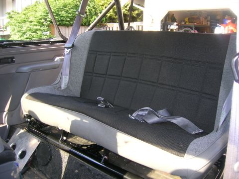 1996 Ford Bronco - The rear bench seat of a 1996 Ford Bronco, showing the upholstery and seatbelt system.