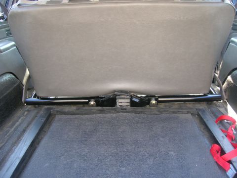 1996 Ford Bronco - The base of a rear seat is shown, with the floor and some straps visible below.