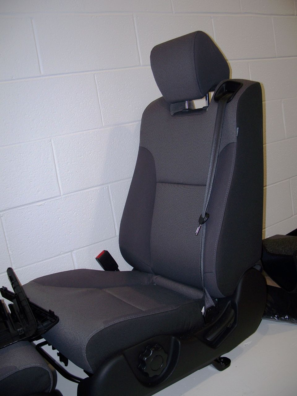 Gray fabric car seat with black plastic base and headrest