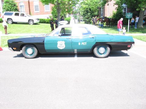 1991 Ford LTD Crown Victoria - Side view of a vintage teal-and-black four-door police sedan lettered POLICE and 9 PCT parked on pavement.