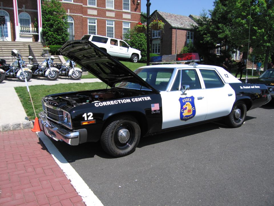 Black and white Essex County Correction Center cruiser with hood open
