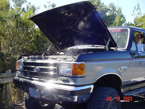 1989 Ford Bronco - 1989 Ford Bronco with hood open, showing steam from the engine bay. Taken July 19, 2003.