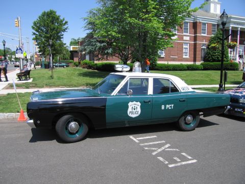 1991 Ford LTD Crown Victoria - Side profile of a teal-and-black vintage police sedan lettered POLICE and 8 PCT with a single roof beacon parked at a show.