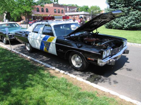 1991 Ford LTD Crown Victoria - vintage black-and-white New Jersey State Police sedan displayed with its hood up at an outdoor car show.