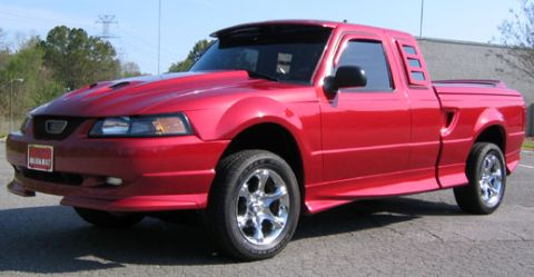 1991 Ford Bronco - Custom red pickup truck with significant body modifications, including a Mustang front end.