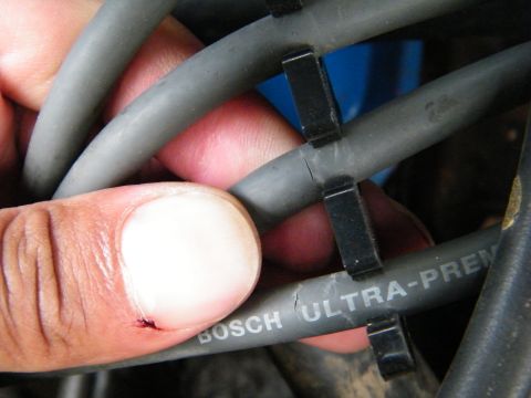 1982 Ford Bronco - Cracked spark plug wires are visible, along with a finger that has a small cut.