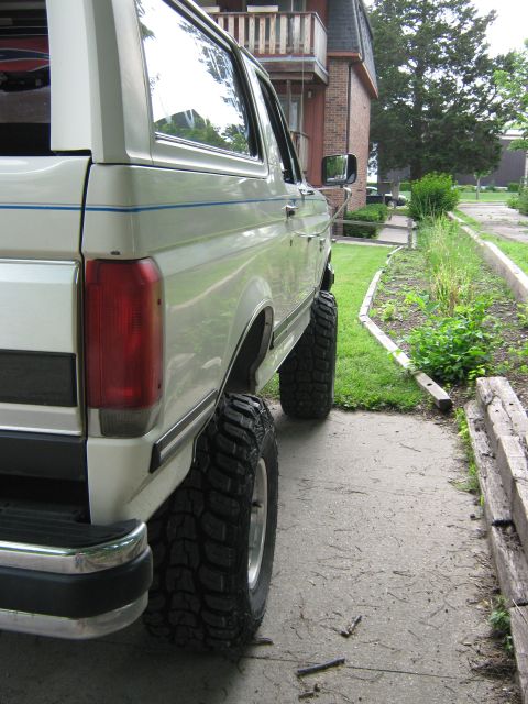 1987 Ford Bronco - This 1987 Ford Bronco is shown from the side, highlighting its lifted suspension and off-road tires.