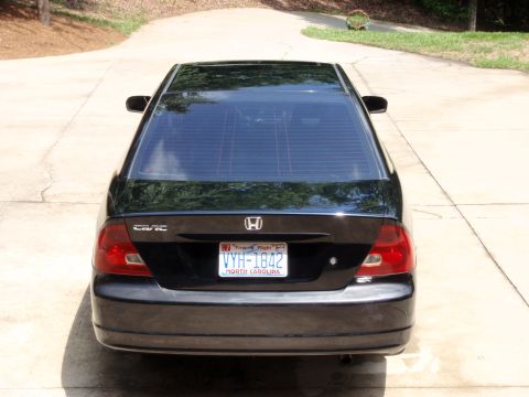 1996 Ford Bronco - The rear of a black Honda Civic sedan is shown parked on a paved driveway.