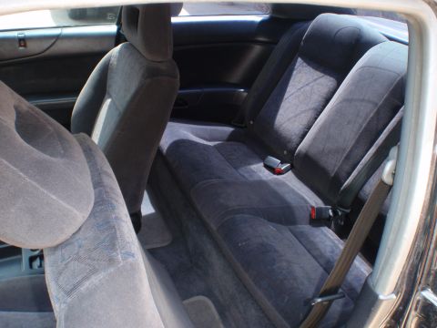 1996 Ford Bronco - The interior of a car shows the back seats and seat belts, with a watermark at the bottom.