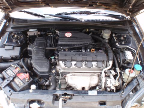 1996 Ford Bronco - The engine bay of a car is shown with various components including the VTEC engine, battery, and air intake.