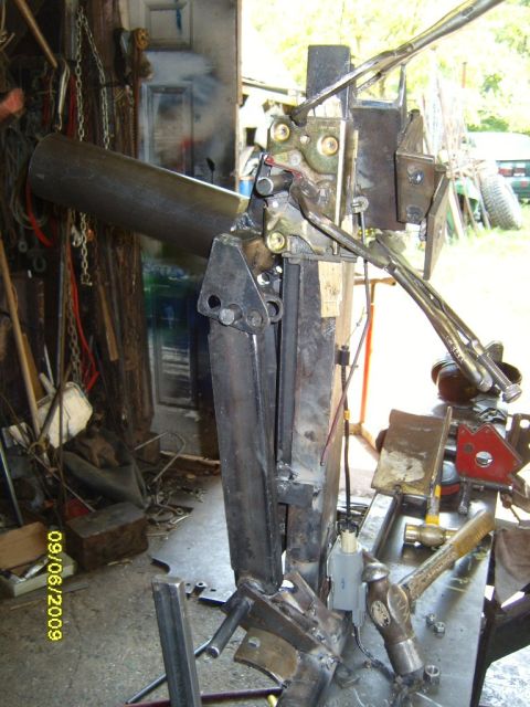 1989 Ford Bronco - A metal fabrication project is shown with various tools and chains in a workshop setting.