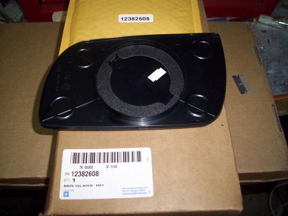 Rear of side mirror glass with part number 12382608 visible