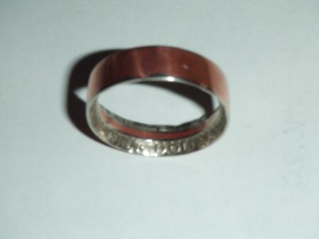 1996 Ford Bronco - A ring with a copper-colored exterior and an engraved silver interior is shown against a white background.
