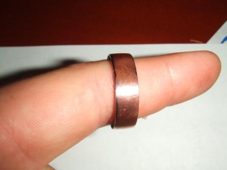1996 Ford Bronco - A copper ring is shown on a finger, with the Supermotors logo visible in the lower right corner.