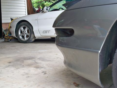 1995 Ford Probe - A white Ford Probe GT is parked next to a gray car in a garage.